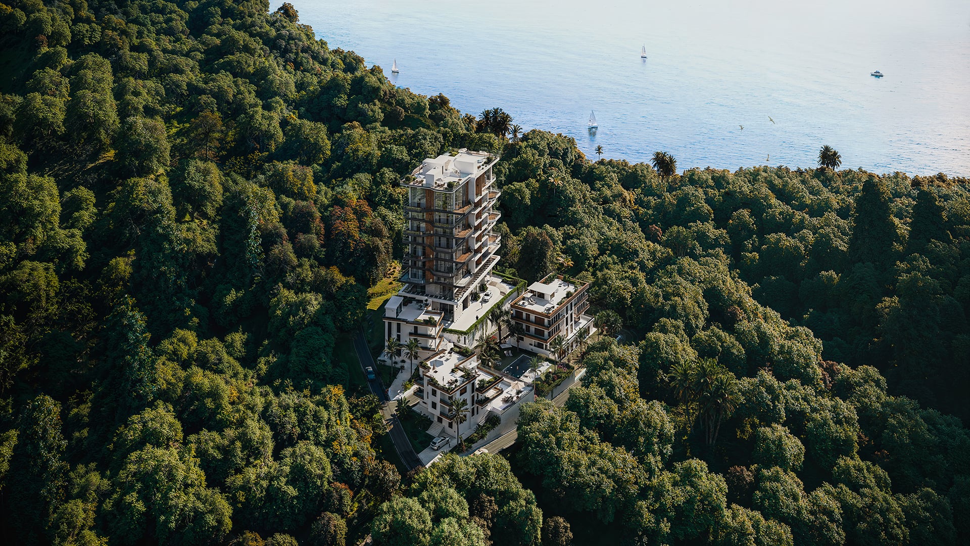 Aerial view of a Semira development between forest and Black Sea coast at golden hour